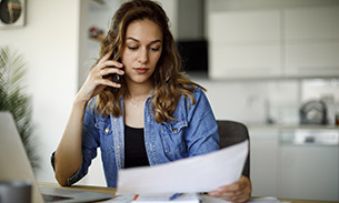 photo-couple-sitting-on-floor-reviewing-finances